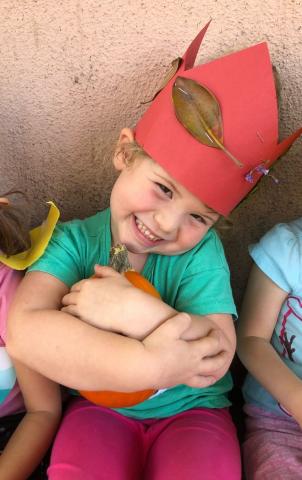 Smiling child holding pumpkin